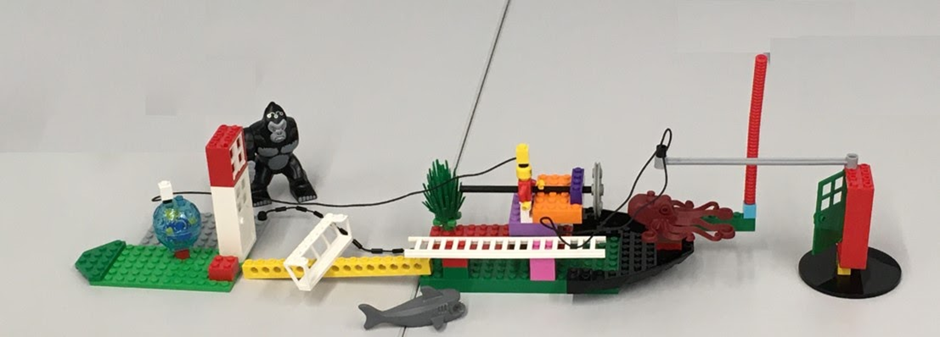 A scene made with LEGO bricks, a gorilla and shark look on a ship which lead onto a door on both ends of the ship.